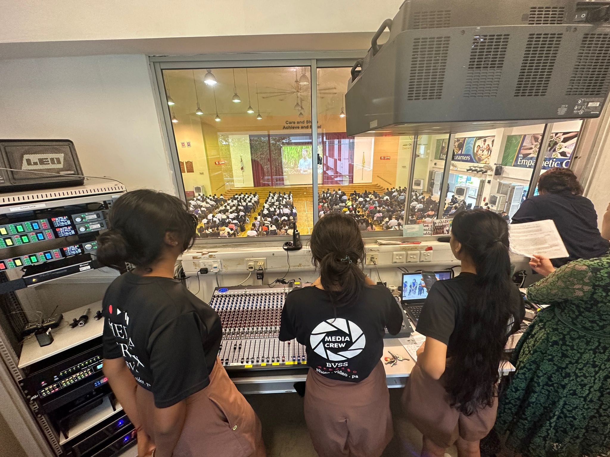 Media & Publicity CCA members operating audio equipment while supporting a school event.